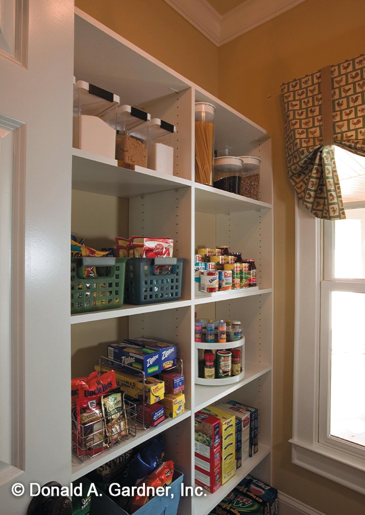 Pantry with open shelving storing food items in clear containers, baskets, cans, boxes, and spice racks.