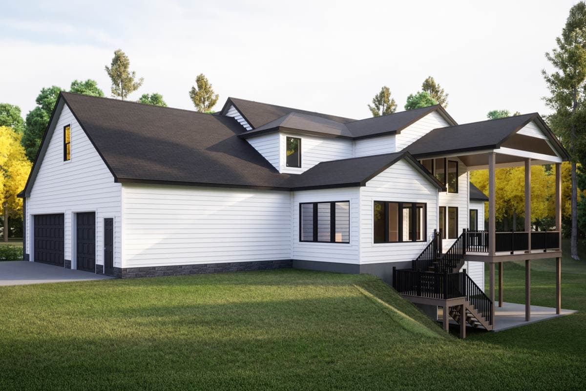 House plan exterior: White sided two-story home with three-car garage, multiple gables, and a large covered deck.