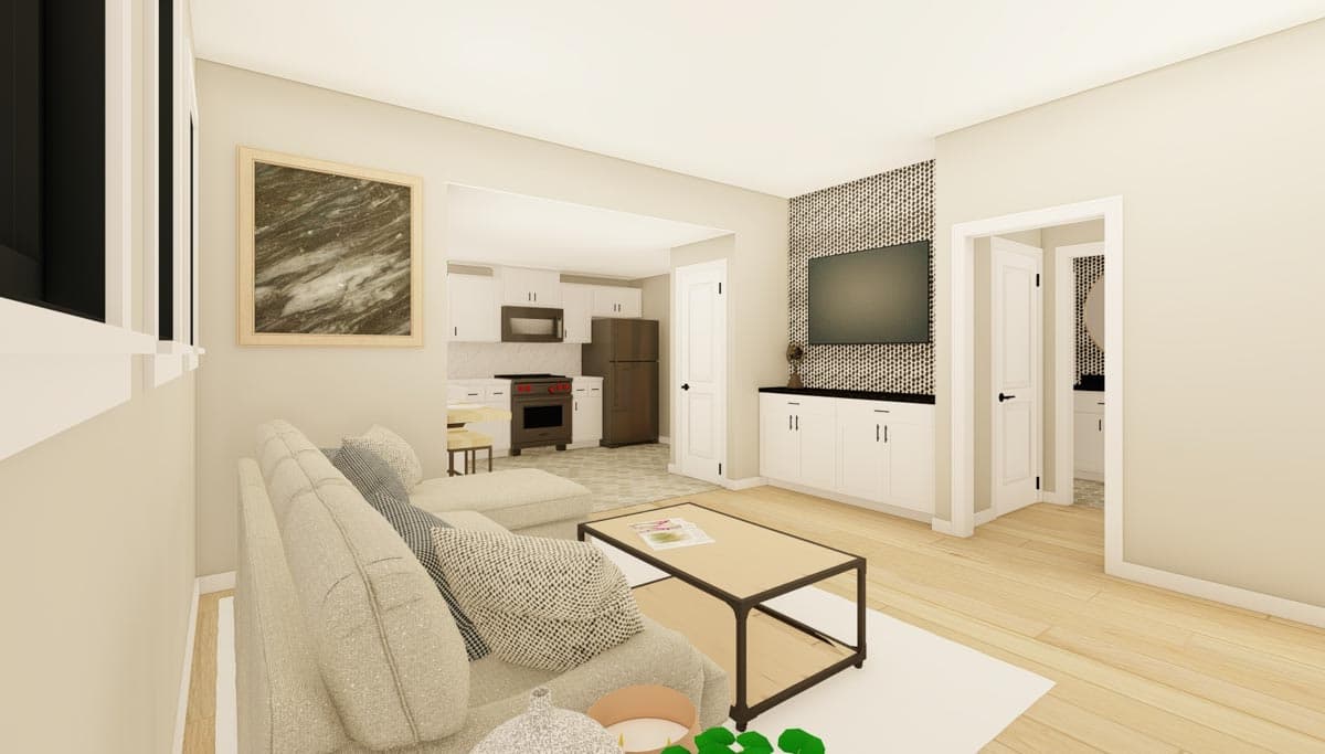 Living area rendering showing sectional sofa, coffee table, and open view to kitchen with white cabinets and stainless steel appliances.