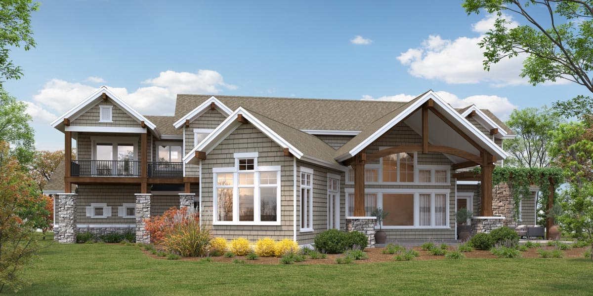Craftsman style house plan exterior with exposed rafter tails, shingle siding, stone accents, and a second-story balcony.
