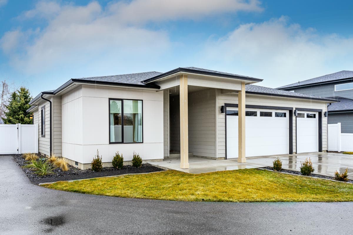 Modern ranch house plan exterior with a covered entry, single-story design, and a three-car garage.