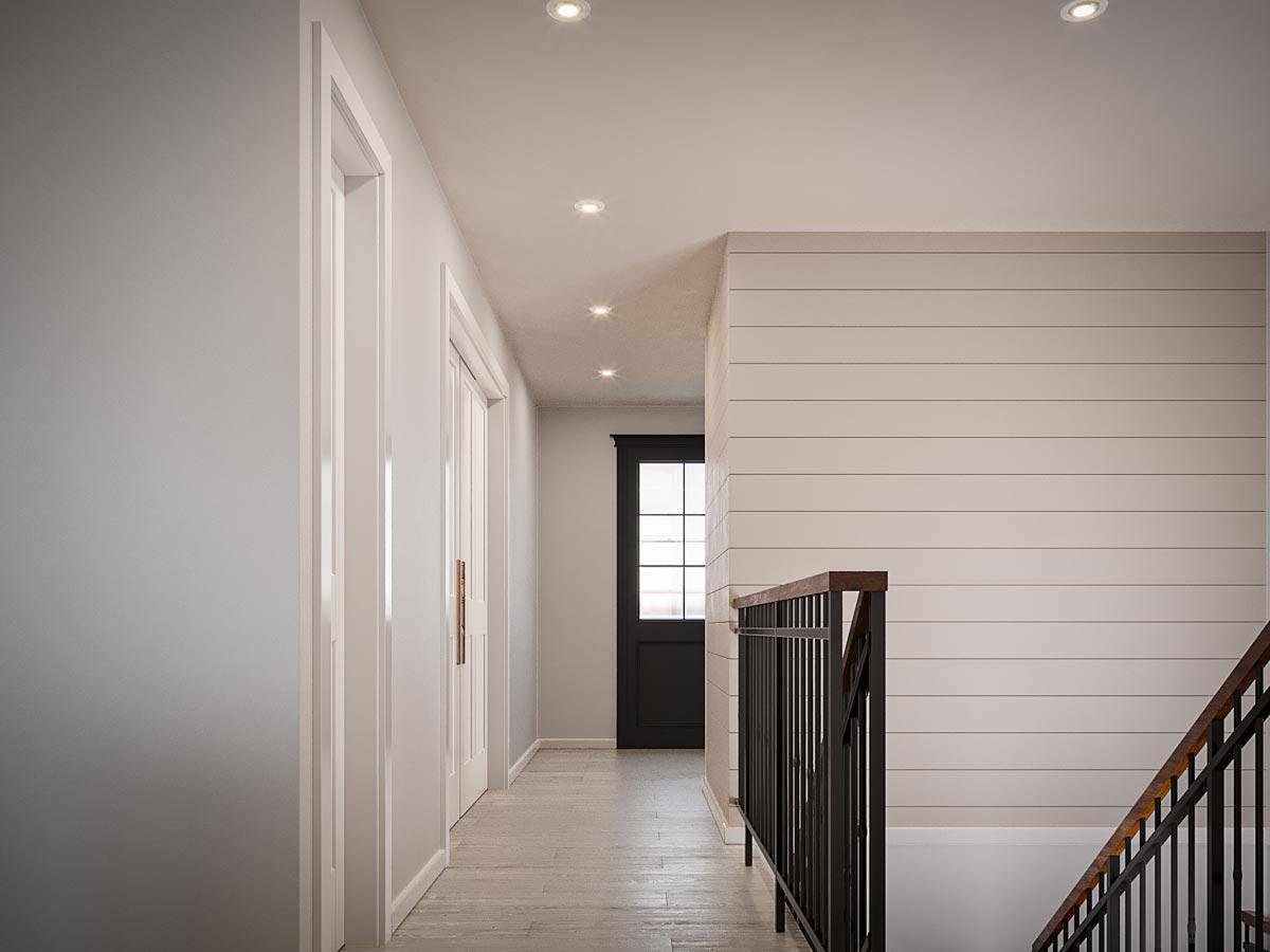 Interior hallway with shiplap wall, wood floor, multiple doors, and dark metal railings on staircase.