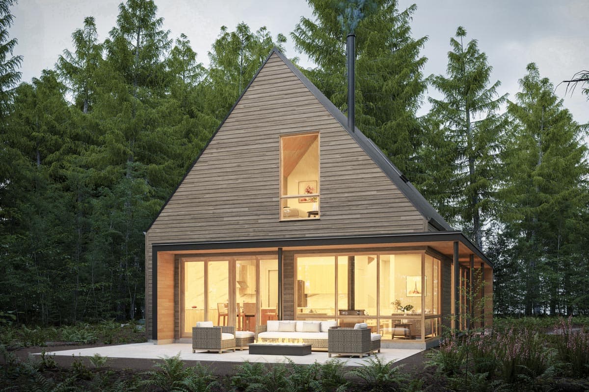 Modern cabin exterior with pitched roof, cedar siding, large glass walls, and a small upper-level window.
