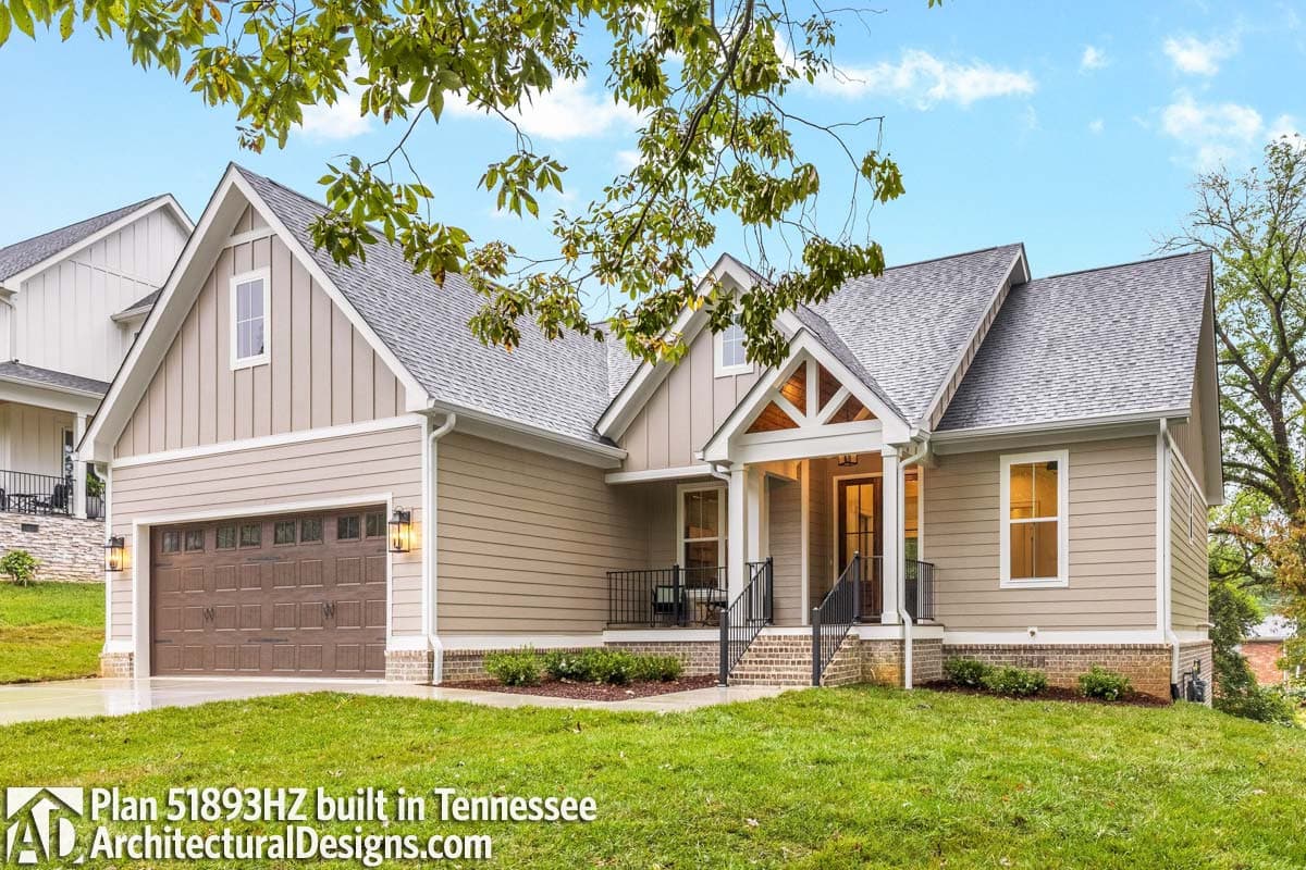 House plan exterior: 1.5 story Modern Farmhouse with gabled dormer, covered entry with exposed beams, and attached garage.