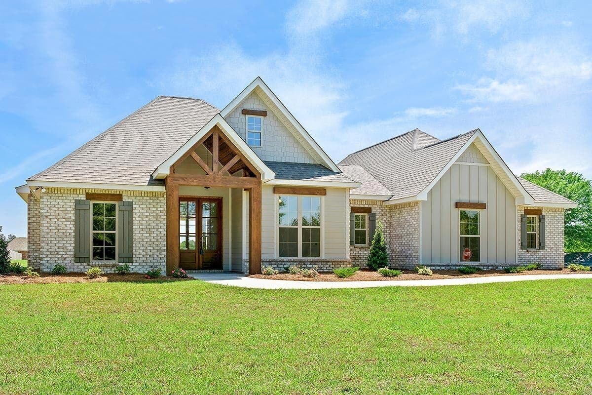 House plan exterior: Ranch style, single story, with a prominent timber-framed entryway, gables, and brick and board-and-batten siding.