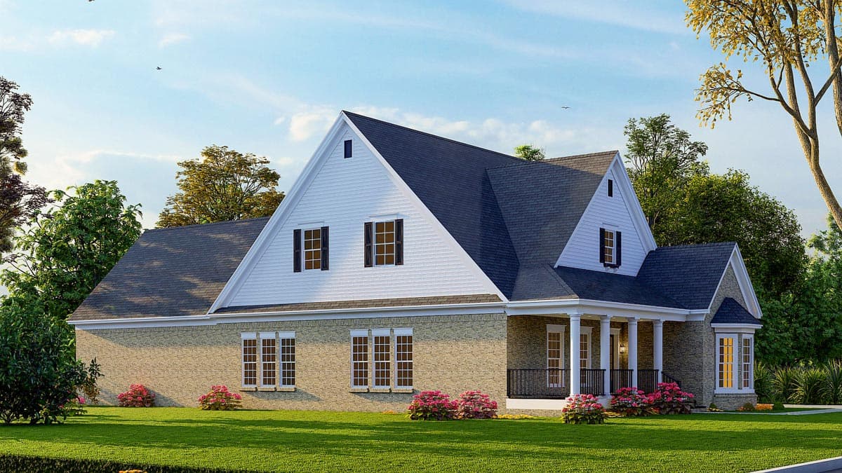 House plan exterior: Two-story home with brick facade, prominent gables, dormers, and covered porch with columns.