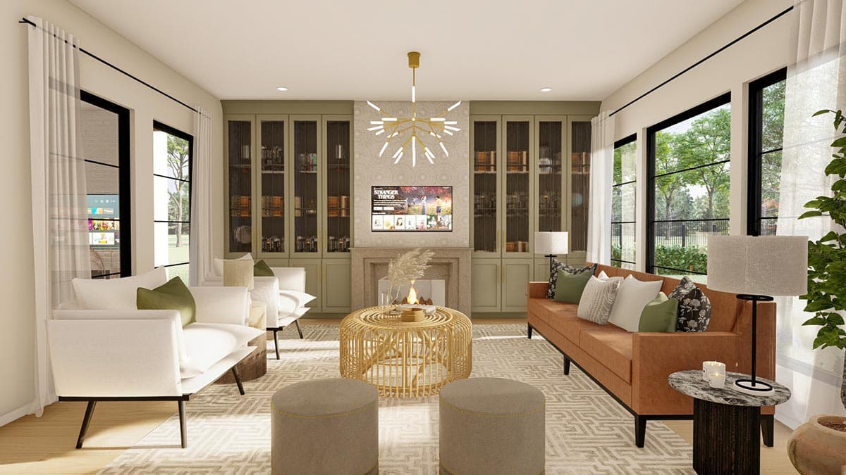 Living room with fireplace, built-in shelving, and large windows. Features seating area with white and tan sofas and ottomans.