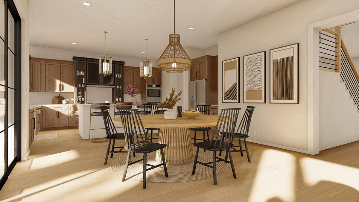 Modern kitchen and dining area with large island, pendant lights, and open staircase. House plan rendering.