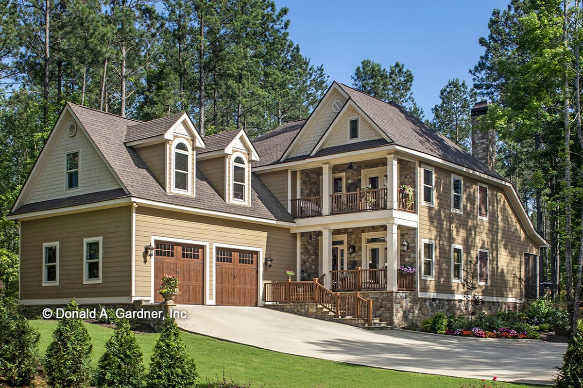 House plan exterior with two stories, Craftsman style. Features include a two-story covered porch, dormers, and a gabled roof.