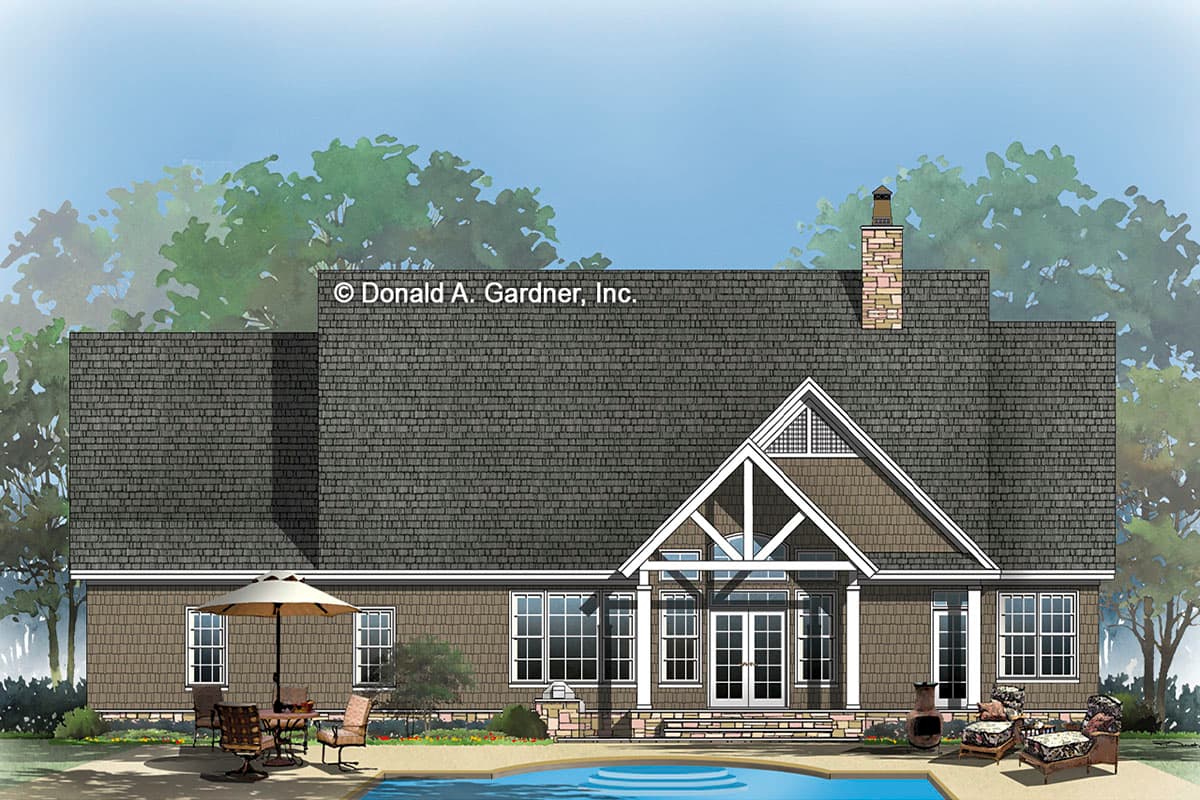 House plan exterior with prominent gable, stone chimney, multiple windows, and French doors leading to a patio with a pool.