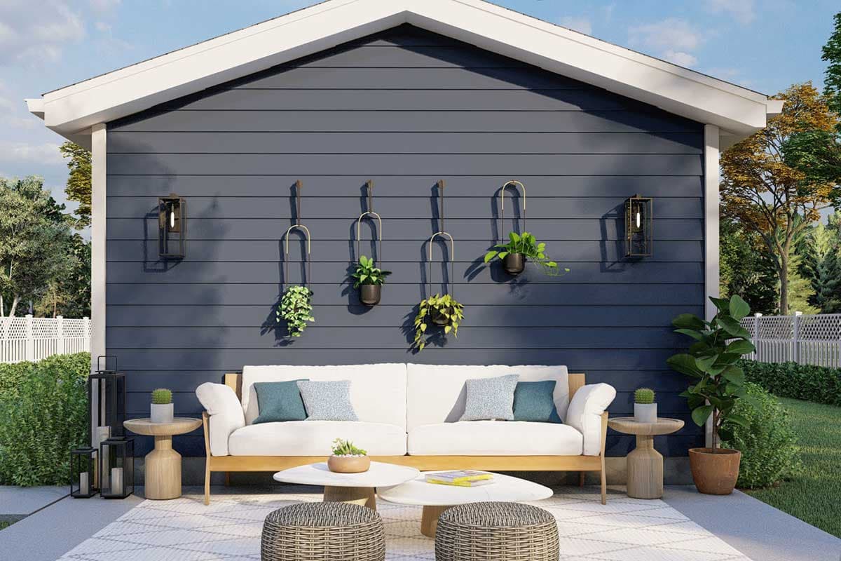 House plan exterior: Modern style, one story, navy siding, prominent gable, porch with seating and decorative wall planters.