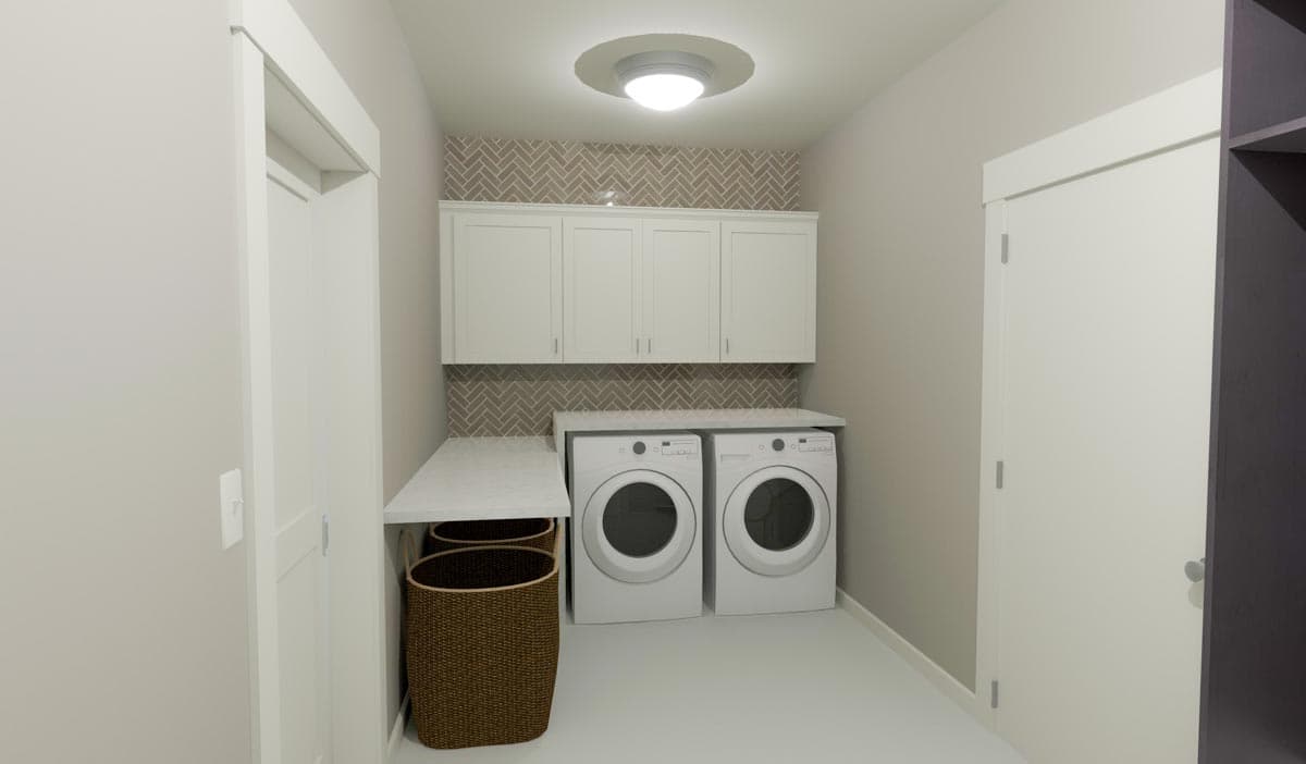 Laundry room with stacked washer and dryer, white cabinets, herringbone tile backsplash, and white countertop.