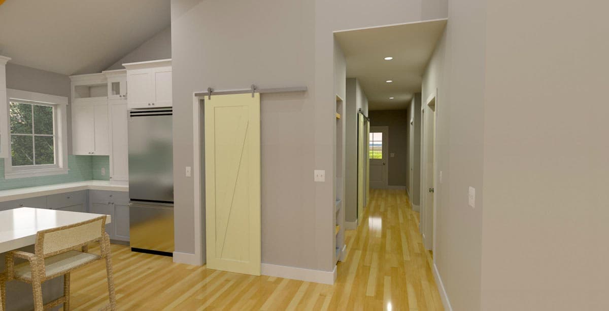 House plan interior rendering of kitchen with vaulted ceiling, barn door, and hallway with recessed lighting and interior doors.