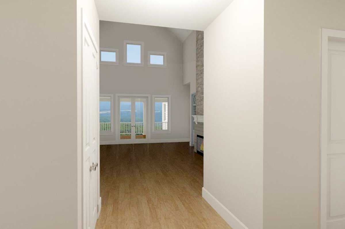Interior rendering: Great room with vaulted ceiling, stone fireplace, and large windows opening to a balcony.
