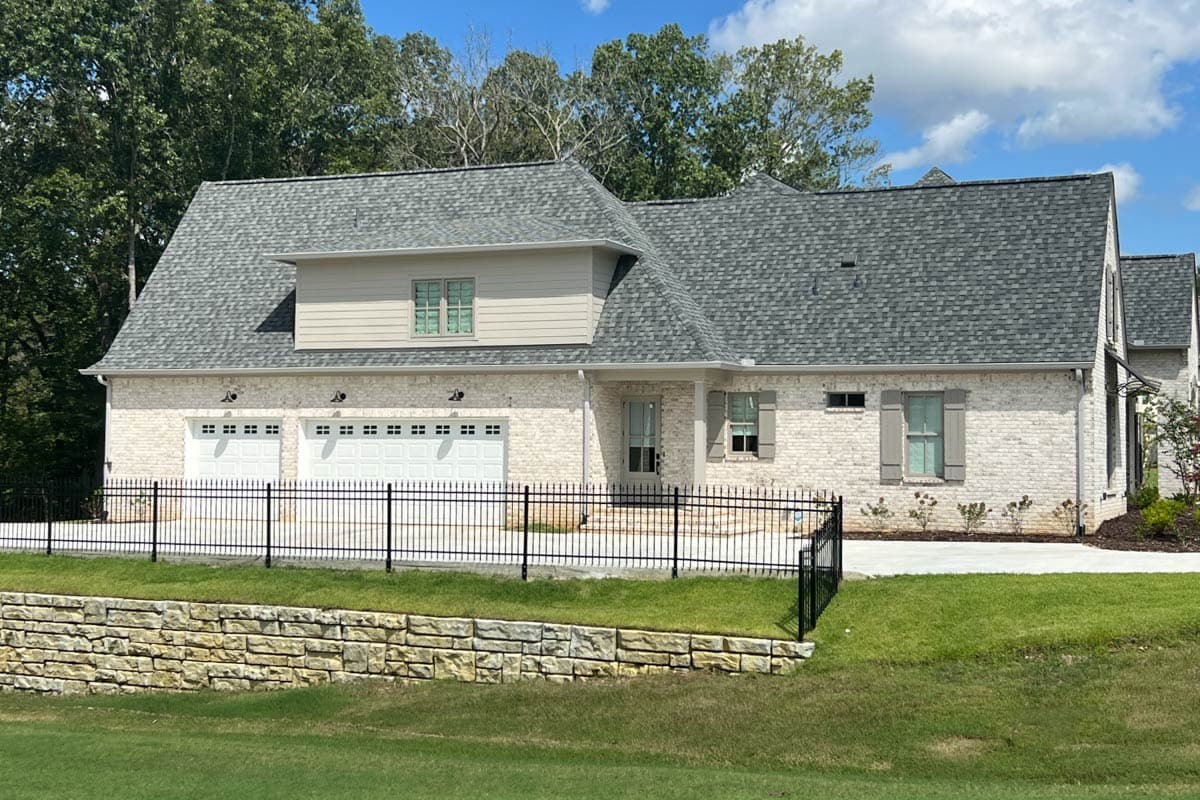 House plan exterior shows a one-story Modern Farmhouse with a three-car garage, gabled dormer, and brick facade.
