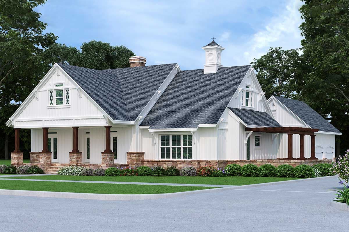 House plan exterior in a farmhouse style with one story. Features include a front porch, gables, a cupola, and a detached garage.