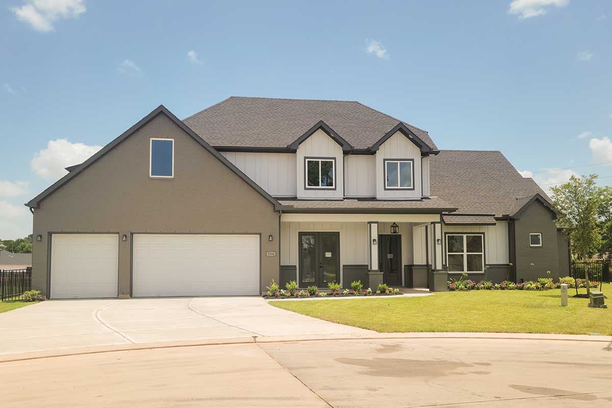 House plan exterior featuring a two-story Modern Farmhouse design. Includes a covered porch, multiple gables, and a two-car garage.