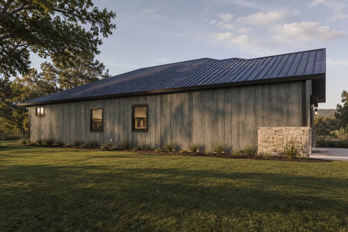 Modern house plan exterior with a prominent gabled roof, stone accents, dual garage doors, and a covered entry with glass-paneled door.
