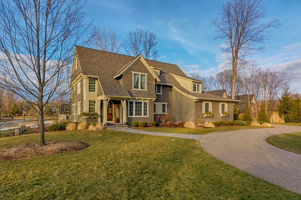 House plan exterior: Two-story home with varied gables, dormers, cedar shingles, and an entry porch.
