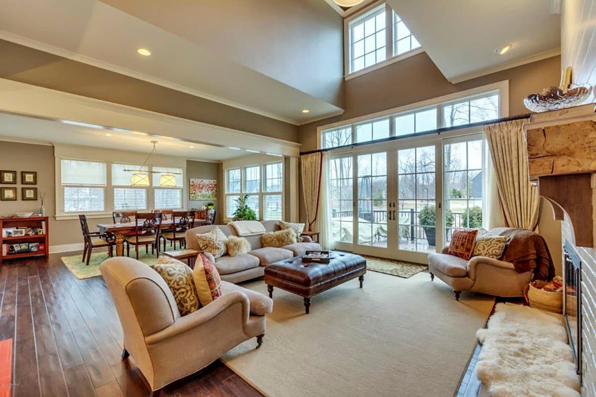 Great room interior with vaulted ceiling, fireplace, and large sliding glass doors to the exterior.