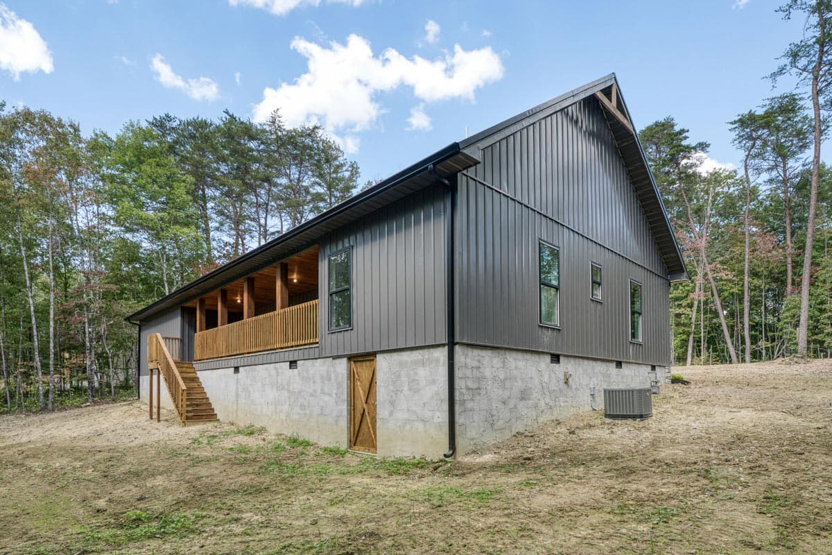 Modern Farmhouse house plan exterior with metal siding, covered porch, and concrete foundation.