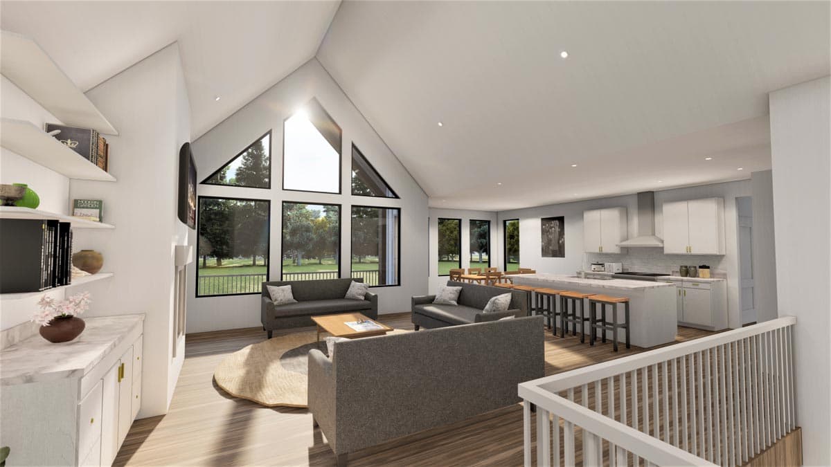Open concept living area with vaulted ceiling, large windows, fireplace, and kitchen island with seating.