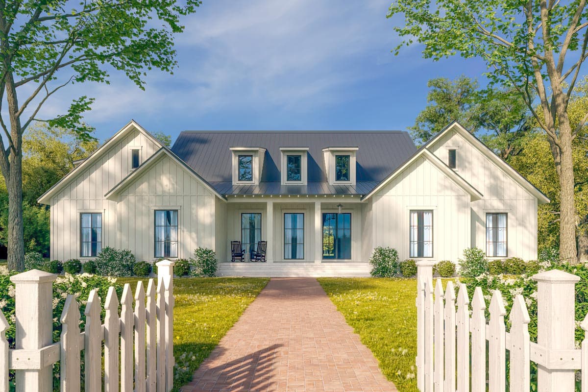 House plan exterior. Two-story Modern Farmhouse with gabled roof, dormers, and front porch. Features include a brick pathway and picket fence.
