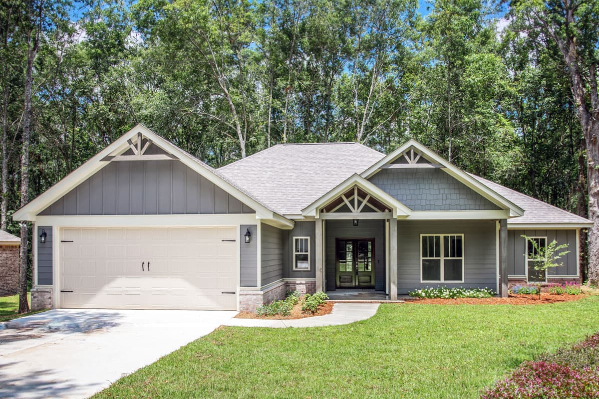 House plan exterior. Single-story Craftsman with front-facing garage, gables, and covered porch entry. Features include shingle and vertical siding.