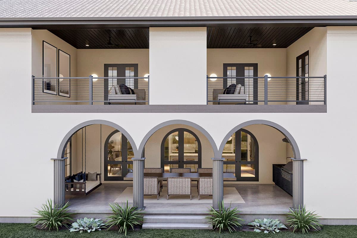 House plan exterior with arched openings, upper balcony, and outdoor kitchen.