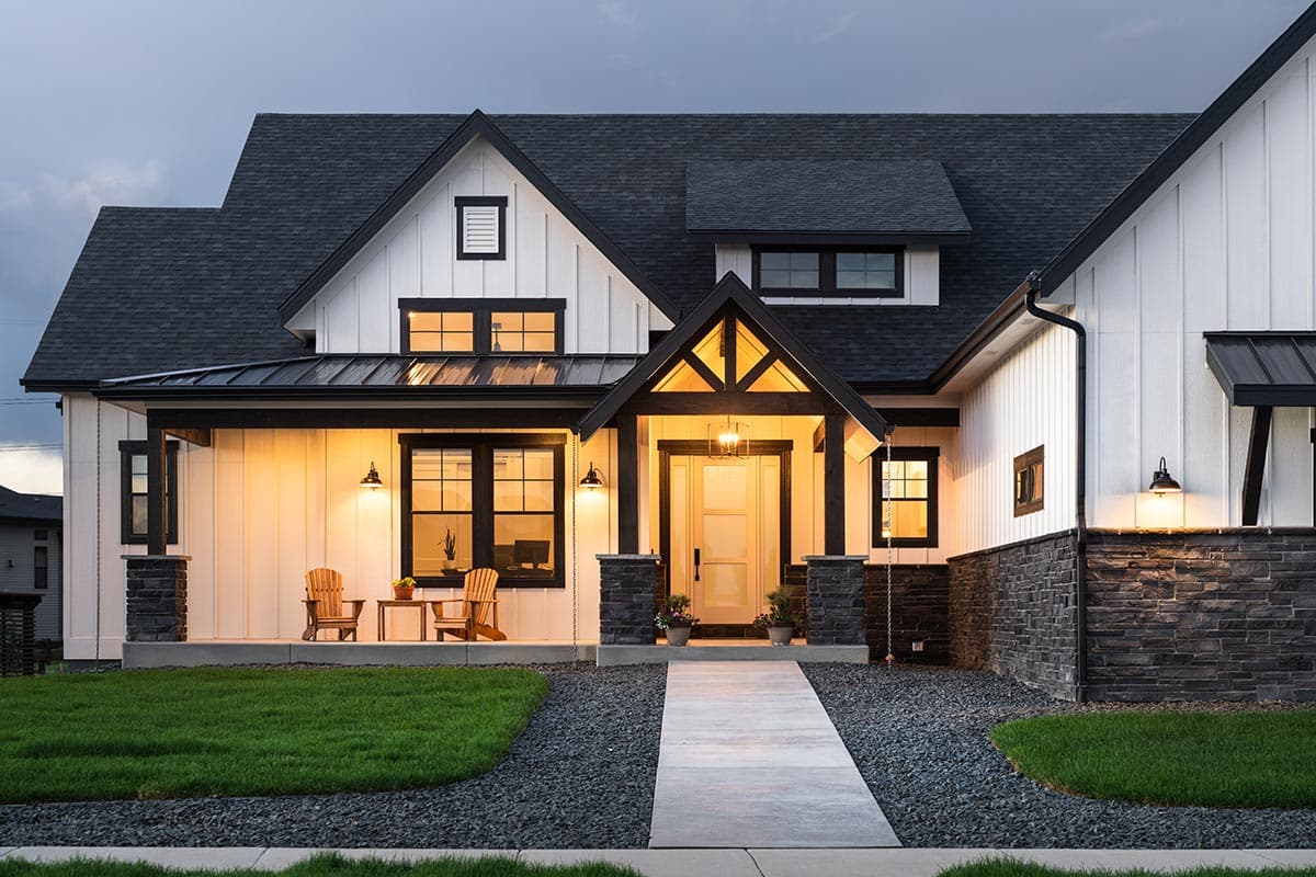Modern Farmhouse house plan exterior with covered porch, stone accents, gable dormers, and prominent entry.
