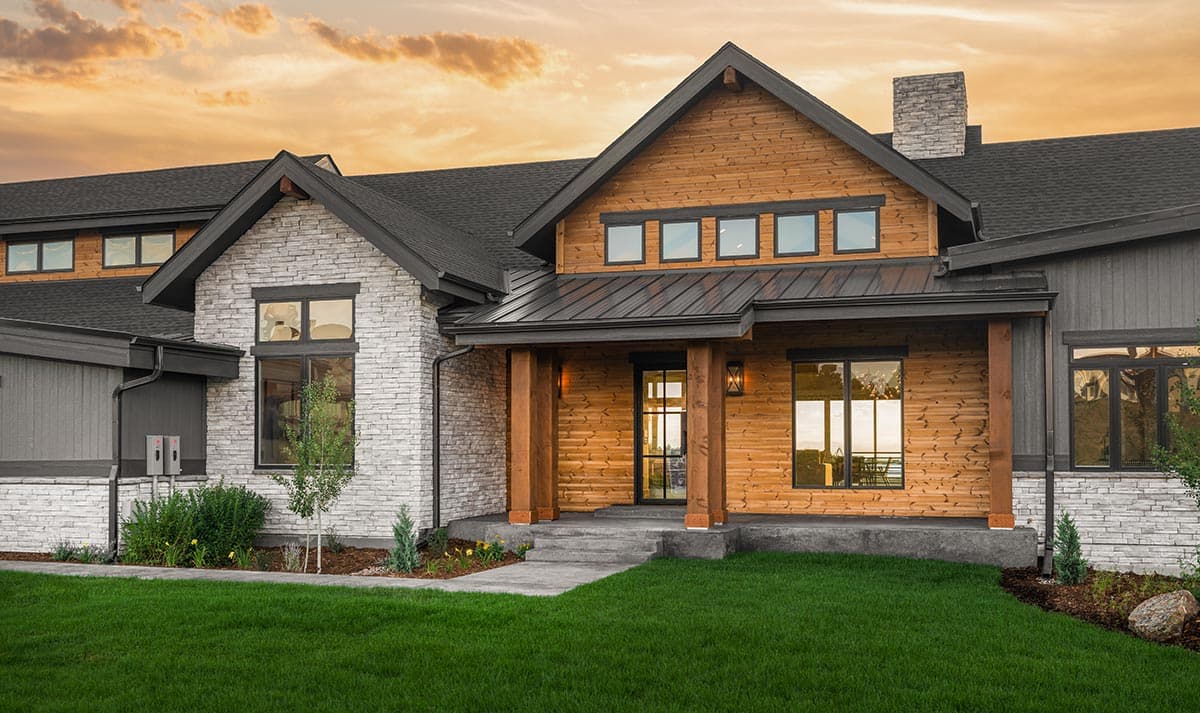 House plan exterior featuring stone and wood siding, a gabled roof, covered porch with timber columns, and multiple gables.