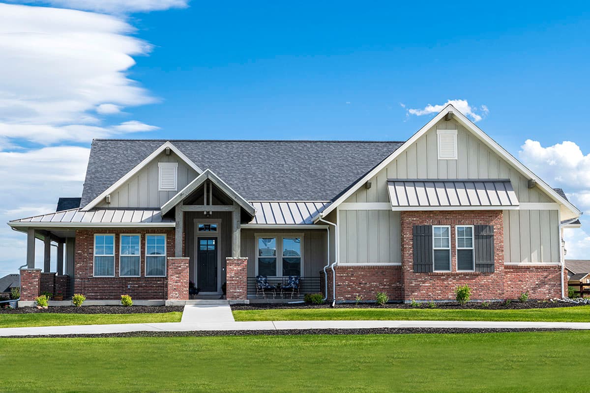 House plan exterior featuring a Craftsman style, single story, with a porch, gables, and metal roof accents.