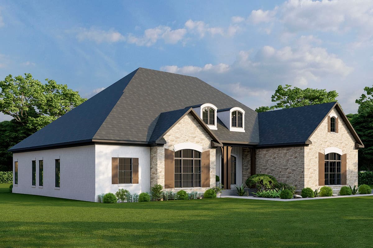House plan exterior: one-story home with stone and white brick facade, arched windows, dormers, and a prominent gabled entrance.