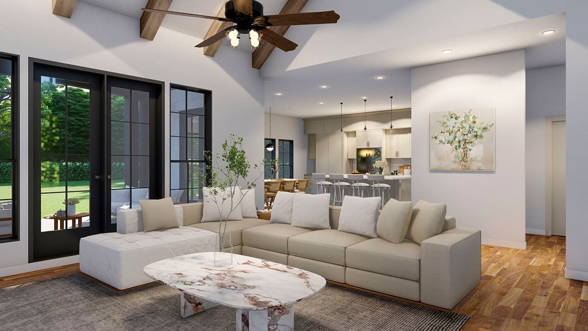 Interior rendering of a great room with vaulted ceiling, exposed beams, sectional sofa, marble coffee table, and open kitchen with island.