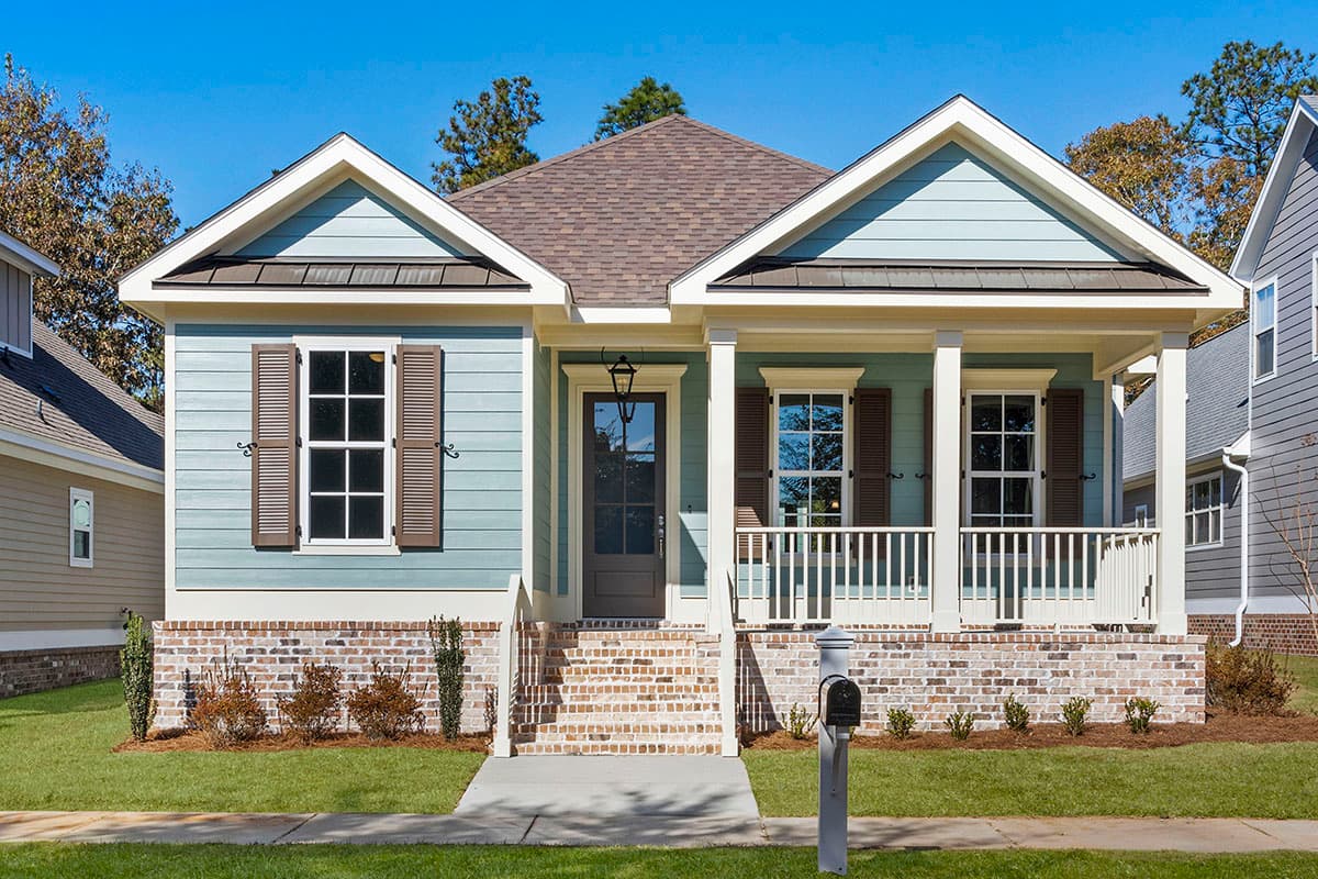 House plan exterior view, single-story Craftsman with front porch, gabled roof, and brick foundation.