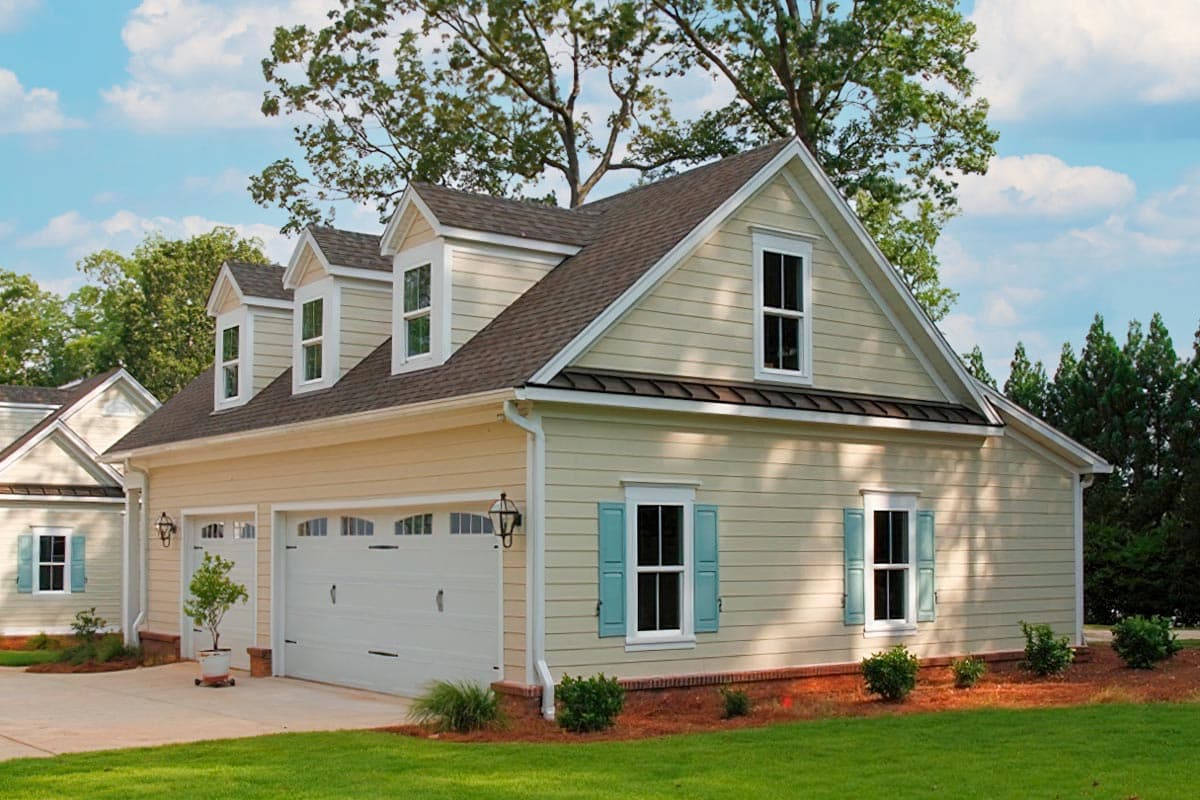 House plan exterior: Two-story Modern Farmhouse with a three-car garage, dormers, and gabled rooflines.