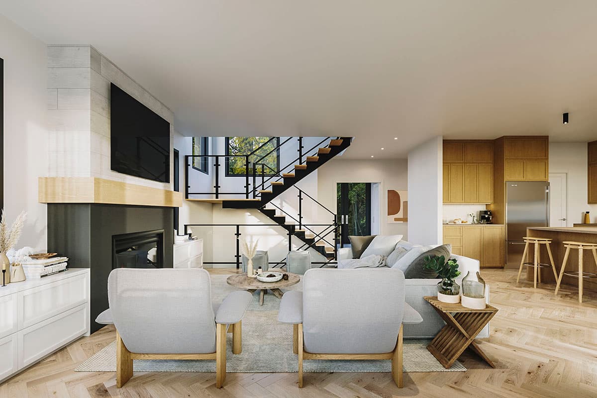 Living area with fireplace, floating stairs, and adjacent kitchen with island. Open-concept floor plan.