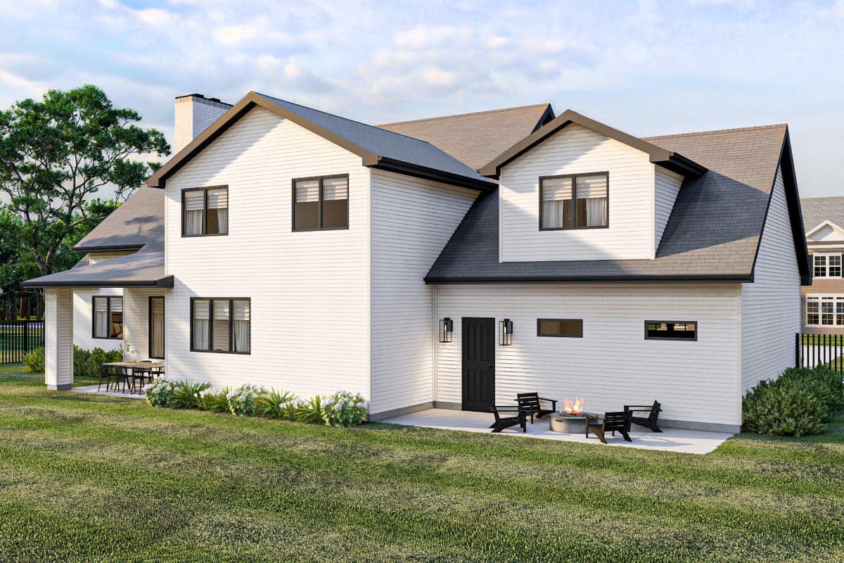Modern Farmhouse style house plan exterior with white siding, gables, prominent chimney, and a rear patio with fire pit.