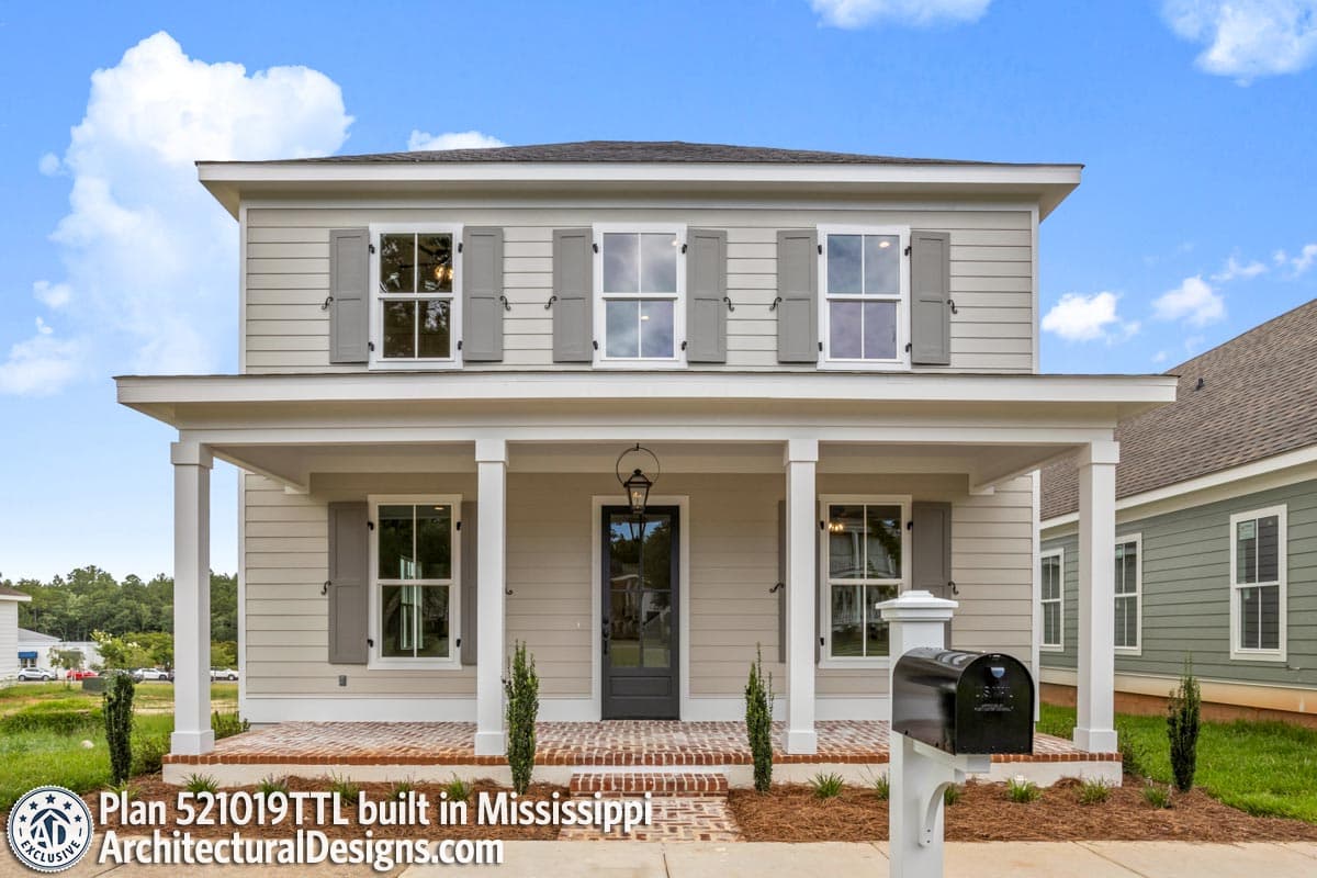 House plan exterior: Two-story home with a full-width covered porch supported by square columns, double-hung windows with shutters.