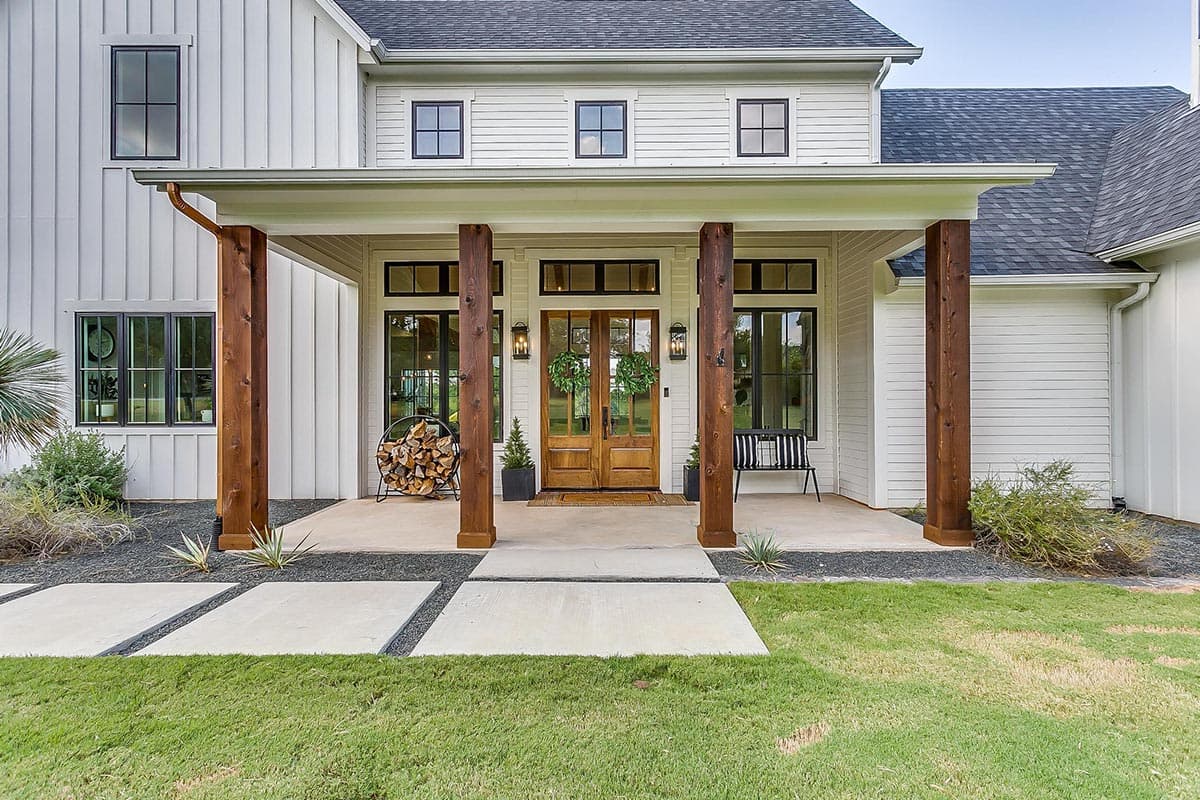 Modern Farmhouse style house plan exterior with a covered porch, double wooden doors, and board and batten siding.