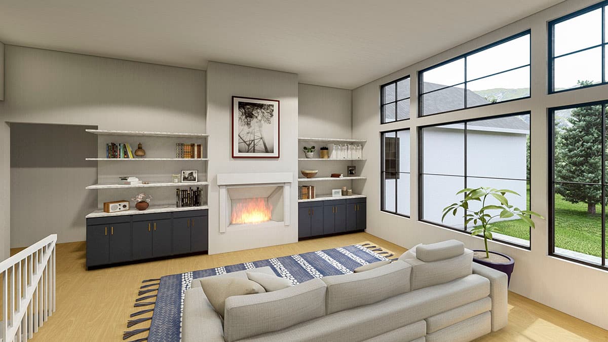 Living room with fireplace, built-in shelving, and large multi-pane windows. Includes sofa and area rug.