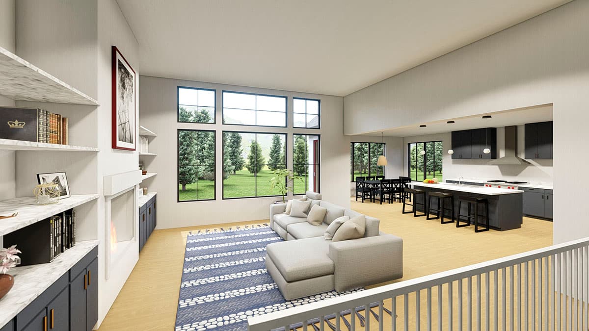 Interior view of a modern open-concept living area with a fireplace, large windows, and an adjacent kitchen with island.