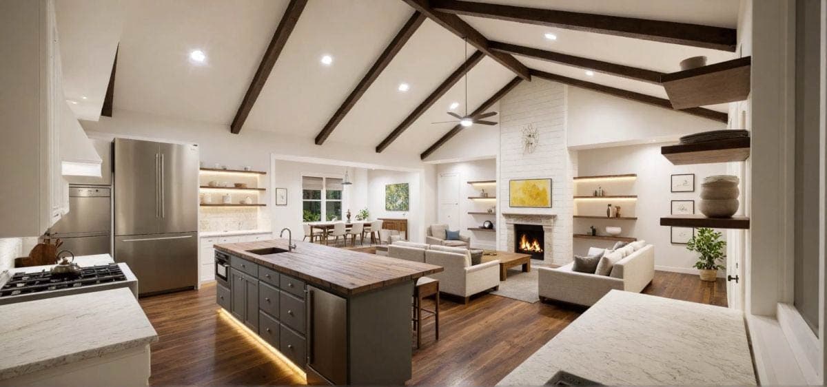 Spacious, open-concept kitchen and living area with hardwood floors, a large island, fireplace, and exposed beams on a vaulted ceiling.