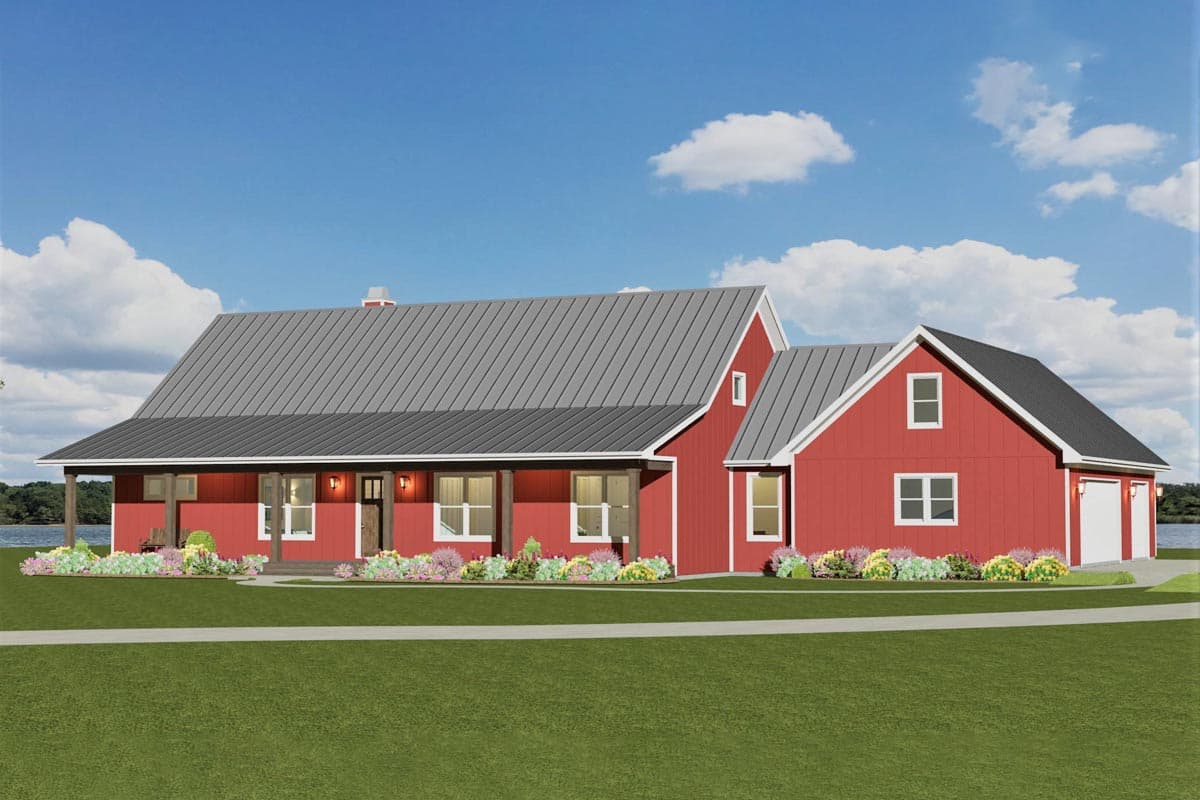 A red farmhouse with a gray roof and a porch sits on a green lawn, with colorful flowers and a blue sky overhead.