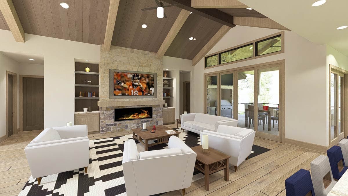 Living room with vaulted beamed ceiling, stone fireplace, entertainment center, seating area, and large windows.