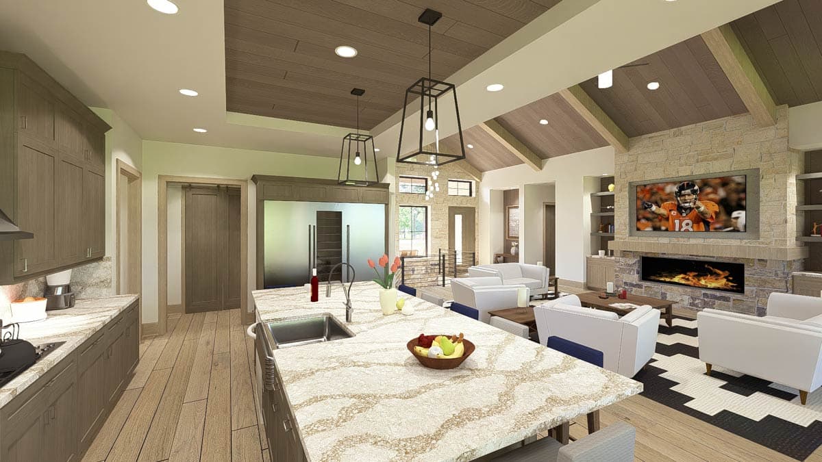 Kitchen and dining area with large island, light wood floors, gray and blue counter stools, and pendant lighting.