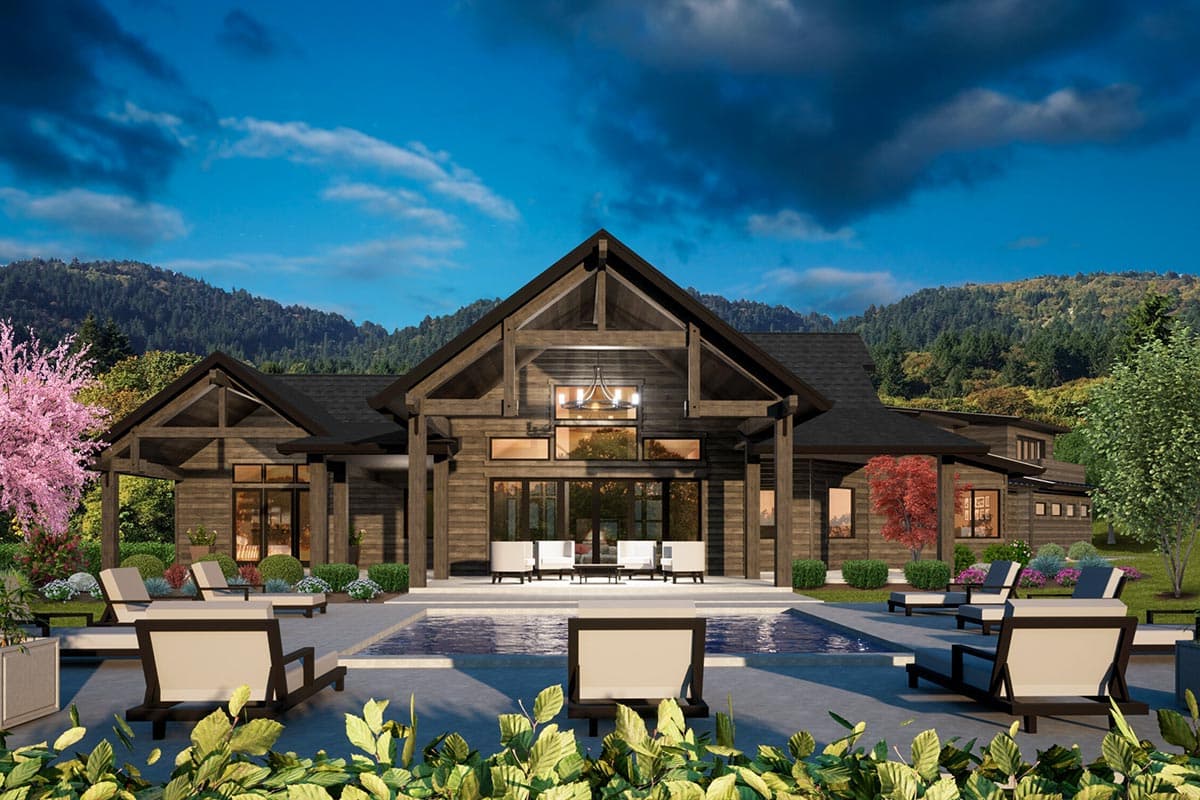 Modern rustic house plan exterior with exposed timber framing, large windows, gabled rooflines, and a covered patio.