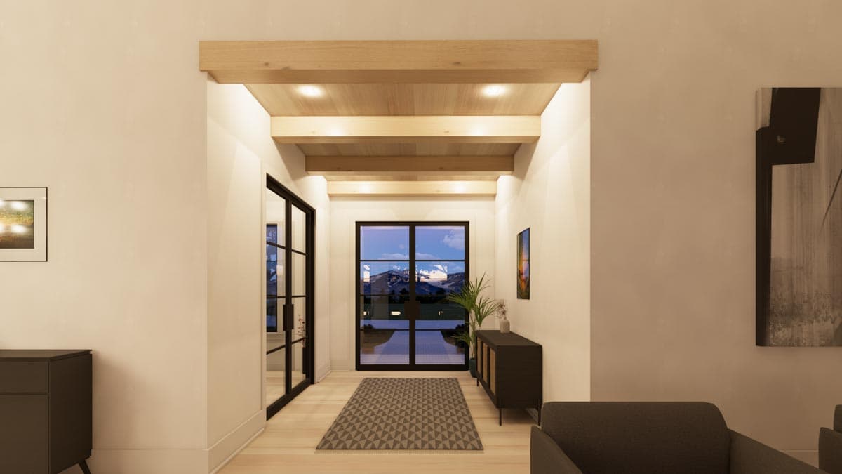 A hallway features light wooden ceiling beams and trim, leading to a window with a mountain view. Artwork and a console table flank the passage.
