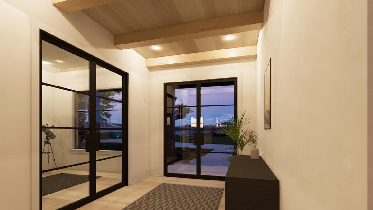 Modern hallway with glass doors and windows, leading to an outdoor view. A wooden ceiling and trim give a bright and airy feel.