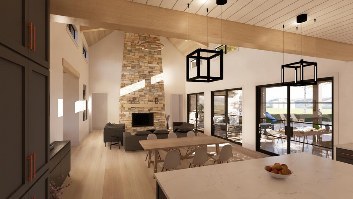 Spacious, modern living room with a stone fireplace, large windows overlooking an outdoor patio, and a dining area with a long wooden table.